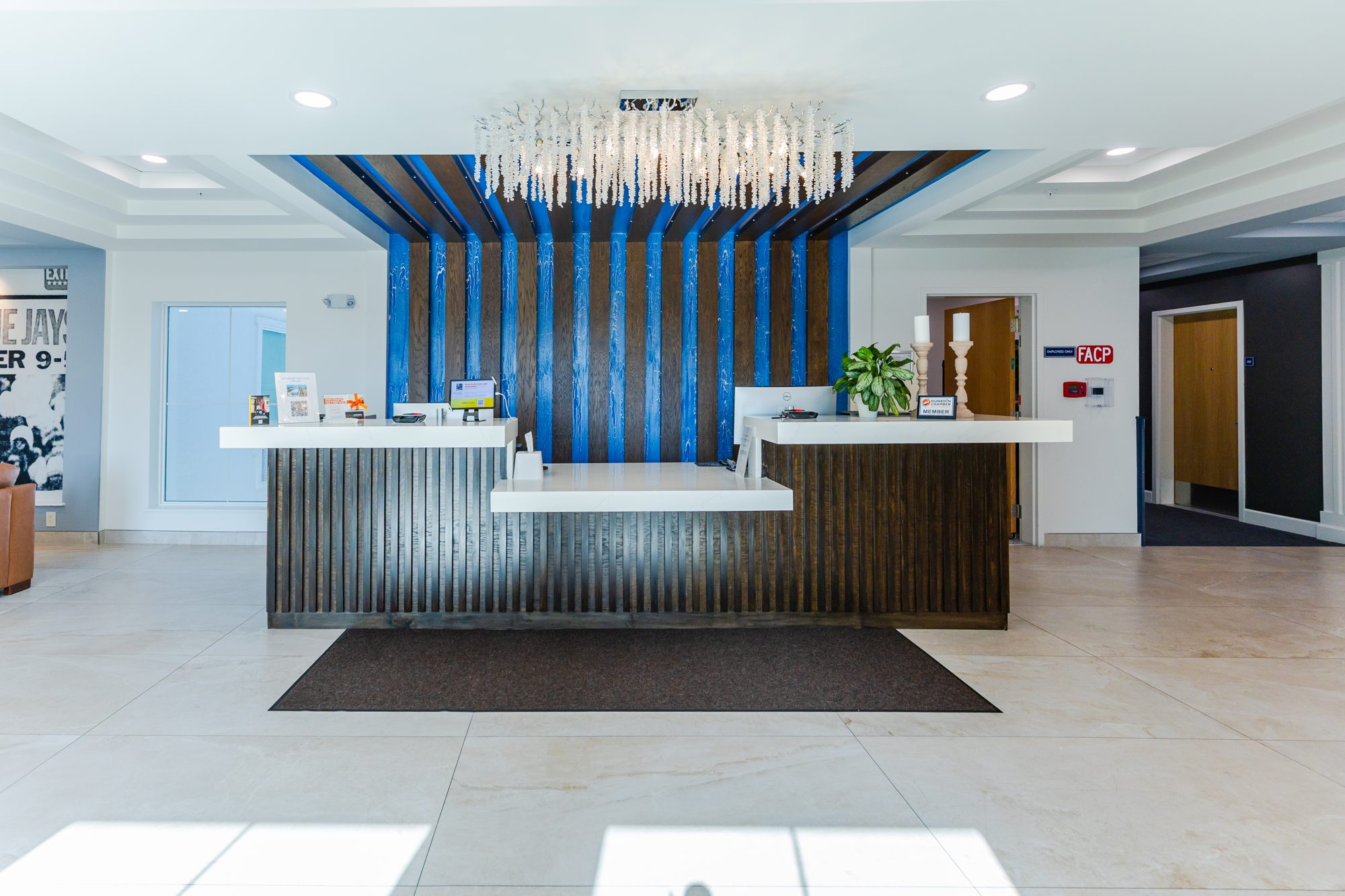 Lobby reception with wood slat ceiling and blue wall